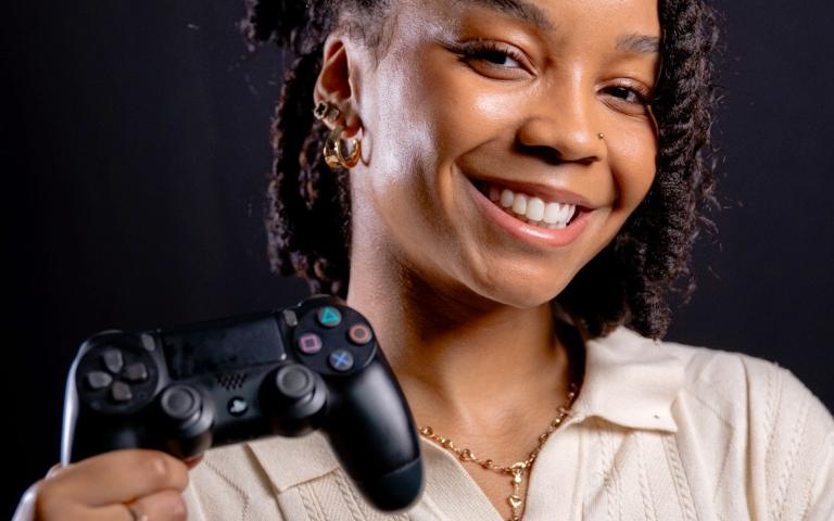 Rachel McFarlane holding a Playstation controller