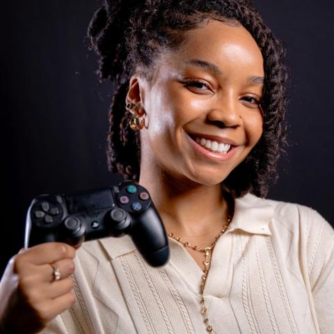 Rachel McFarlane holding a Playstation controller